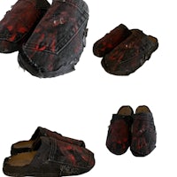 a pair of slippers with red paint on them