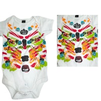 a white baby bodysuit with colorful designs on it